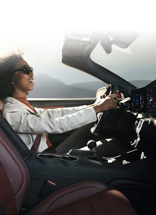 Person sitting in the driver’s seat of a 2024 Ford Mustang® convertible | Summerville Ford in Summerville SC